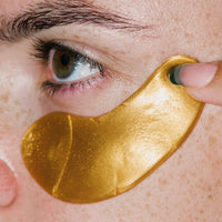 Close up of Hydra-Bright Golden Eye Treatment Mask on skin.
