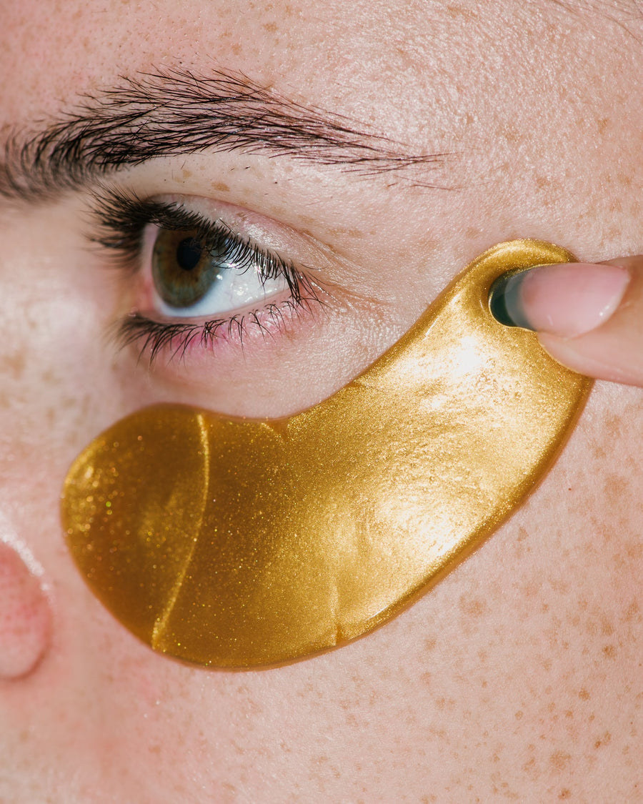 Close up of Hydra-Bright Golden Eye Treatment Mask on skin.